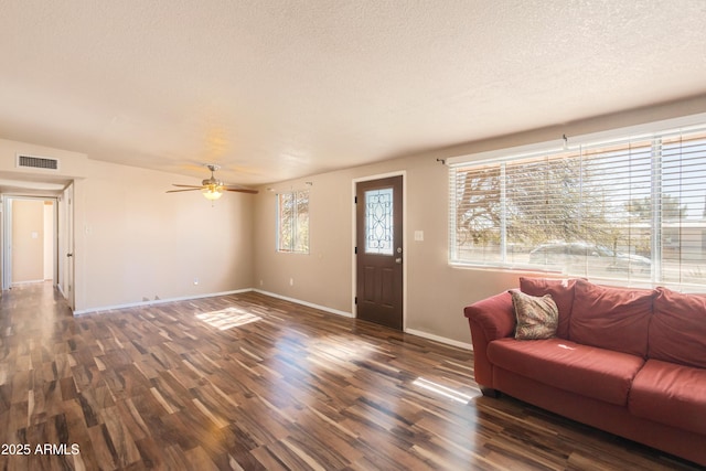 4565 Aspen Dr, Sierra Vista, AZ 85635 - living room featuring a textured ceiling, a wealth of natural light, ceiling fan, and dark hardwood / wood-style flooring