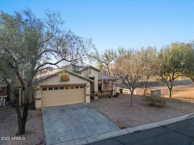 view of front of property with a garage, concrete driveway, and stucco siding