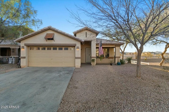 view of front of house with concrete driveway, an attached garage, a tile roof, and stucco siding