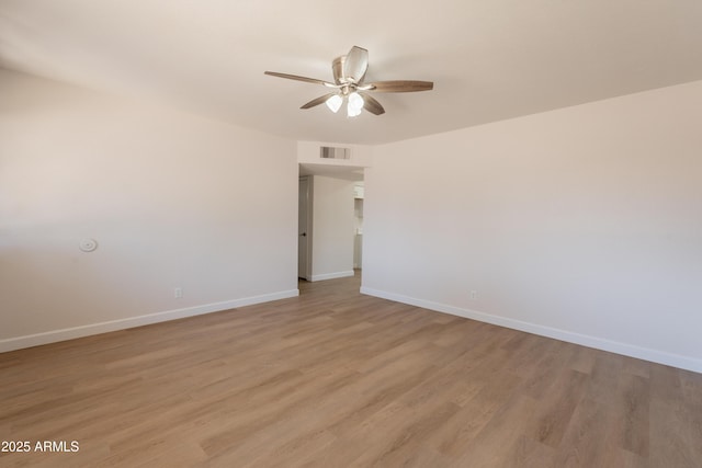 1310 E Ironwood Dr, Buckeye, AZ 85326 - spare room with a ceiling fan, light wood-style floors, and baseboards