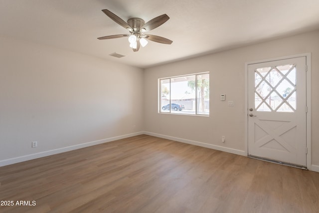 1310 E Ironwood Dr, Buckeye, AZ 85326 - foyer with light wood-style flooring, a ceiling fan, and baseboards