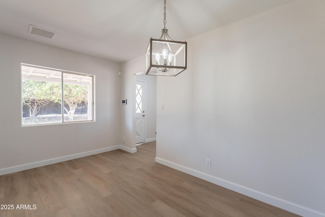 1310 E Ironwood Dr, Buckeye, AZ 85326 - unfurnished room with a chandelier, light wood-style flooring, and baseboards