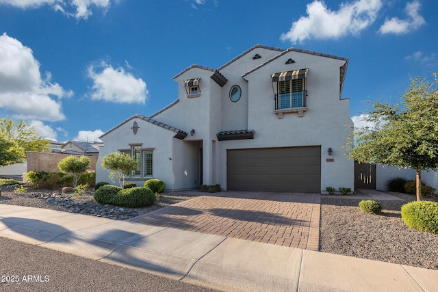 21194 W Hillcrest Blvd, Buckeye, AZ 85396 - mediterranean / spanish-style home featuring stucco siding, decorative driveway, a garage, and a tiled roof