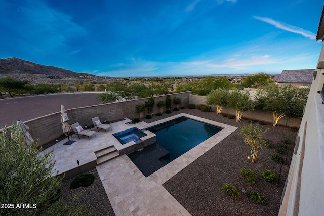 21194 W Hillcrest Blvd, Buckeye, AZ 85396 - view of pool with a patio area, a fenced backyard, a mountain view, and a pool with connected hot tub
