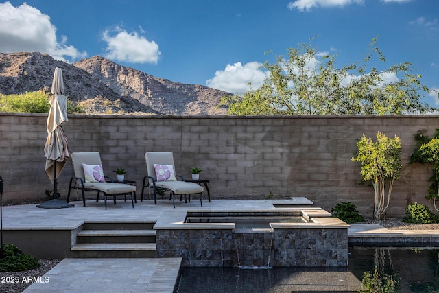 21194 W Hillcrest Blvd, Buckeye, AZ 85396 - fenced backyard with a mountain view, an in-ground hot tub, and a patio