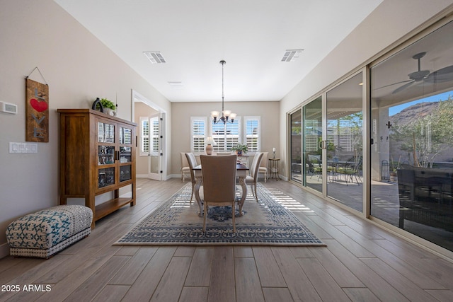 21194 W Hillcrest Blvd, Buckeye, AZ 85396 - dining room featuring wood finished floors, a chandelier, baseboards, and a ceiling fan