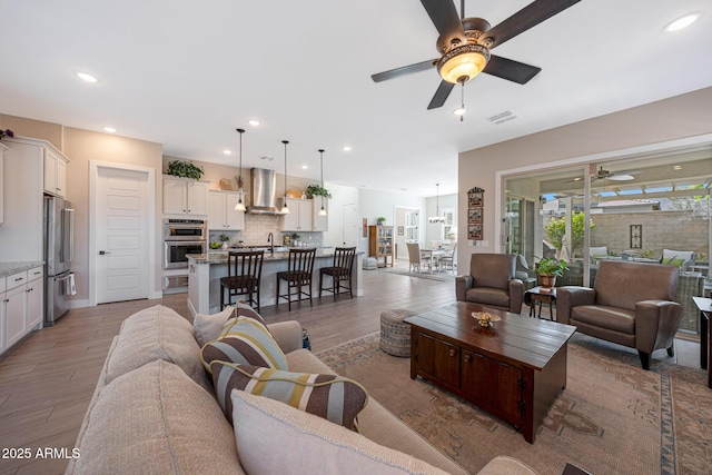 21194 W Hillcrest Blvd, Buckeye, AZ 85396 - living room with ceiling fan, light wood-type flooring, and recessed lighting