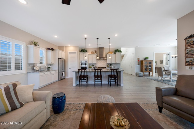 21194 W Hillcrest Blvd, Buckeye, AZ 85396 - living area with light wood-type flooring, a ceiling fan, and recessed lighting