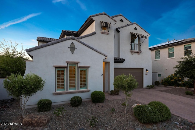 21194 W Hillcrest Blvd, Buckeye, AZ 85396 - mediterranean / spanish home with a balcony, an attached garage, decorative driveway, a tile roof, and stucco siding