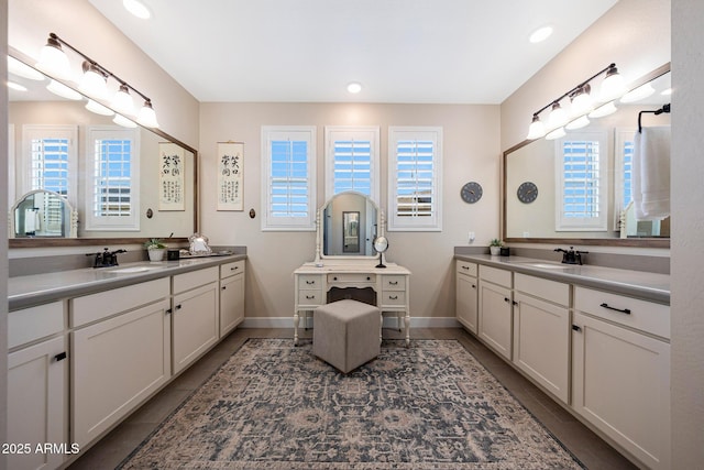 21194 W Hillcrest Blvd, Buckeye, AZ 85396 - bathroom featuring plenty of natural light, two vanities, tile patterned flooring, and recessed lighting