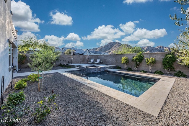 21194 W Hillcrest Blvd, Buckeye, AZ 85396 - view of swimming pool featuring a fenced backyard, a patio, a pool with connected hot tub, and a mountain view