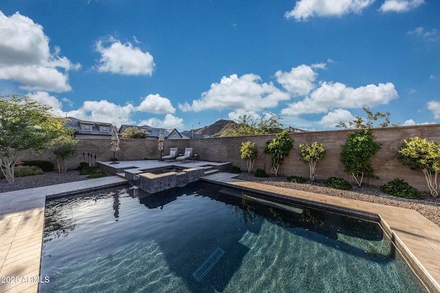 21194 W Hillcrest Blvd, Buckeye, AZ 85396 - view of pool featuring a fenced backyard, a pool with connected hot tub, and a patio area