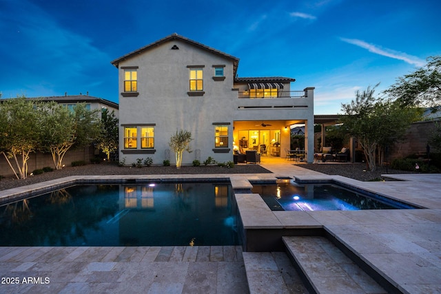 21194 W Hillcrest Blvd, Buckeye, AZ 85396 - back of house featuring a balcony, a patio area, a fenced backyard, an in-ground hot tub, and an outdoor pool