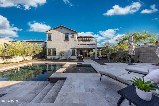 21194 W Hillcrest Blvd, Buckeye, AZ 85396 - rear view of property featuring a ceiling fan, a patio area, a fenced backyard, a pool with connected hot tub, and stucco siding