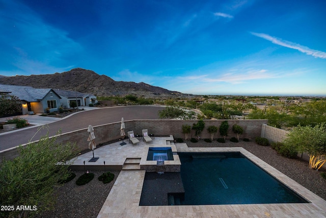 21194 W Hillcrest Blvd, Buckeye, AZ 85396 - view of swimming pool featuring a mountain view, a patio, a fenced backyard, and a pool with connected hot tub