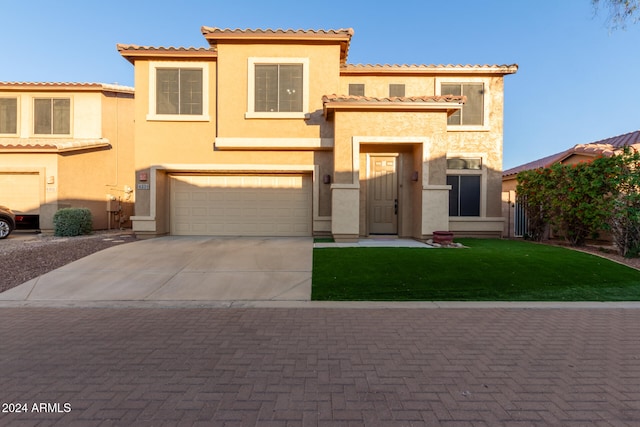 mediterranean / spanish-style home with a front lawn and a garage