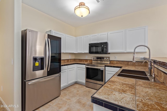 6321 S Teresa Dr, Chandler, AZ 85249 - kitchen featuring appliances with stainless steel finishes, a sink, tile countertops, and white cabinets