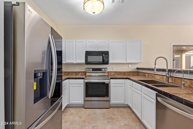 6321 S Teresa Dr, Chandler, AZ 85249 - kitchen featuring stainless steel appliances, a sink, white cabinetry, and dark countertops
