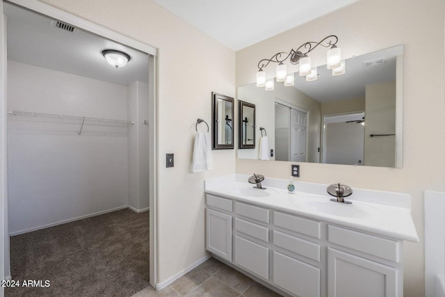 6321 S Teresa Dr, Chandler, AZ 85249 - full bathroom featuring double vanity, a spacious closet, and baseboards