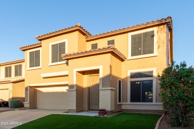 6321 S Teresa Dr, Chandler, AZ 85249 - view of front of home with a garage, driveway, stucco siding, and a front lawn