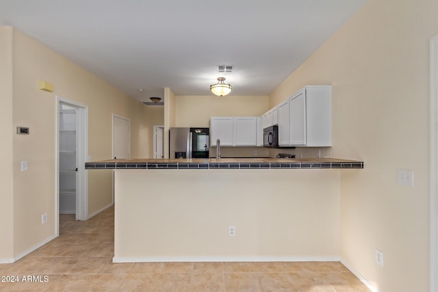 6321 S Teresa Dr, Chandler, AZ 85249 - kitchen featuring stainless steel refrigerator with ice dispenser, black microwave, white cabinetry, a peninsula, and tile counters