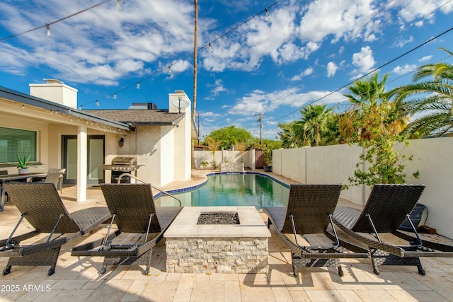 view of swimming pool featuring a fenced in pool, grilling area, an outdoor fire pit, a patio area, and a fenced backyard