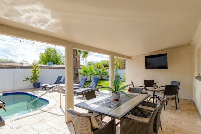 view of patio / terrace with outdoor dining space, a fenced backyard, and a fenced in pool