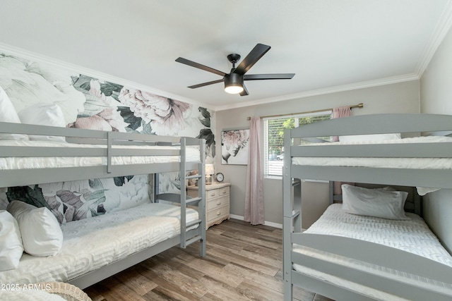 bedroom with ceiling fan, crown molding, baseboards, and wood finished floors