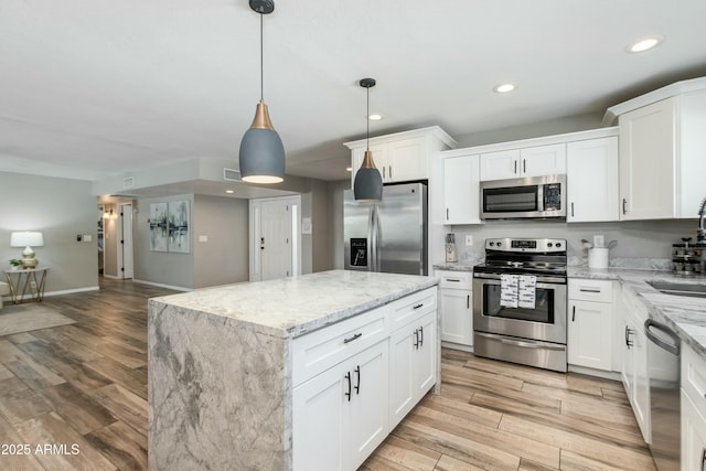 kitchen featuring a center island, stainless steel appliances, recessed lighting, light wood-style floors, and white cabinets