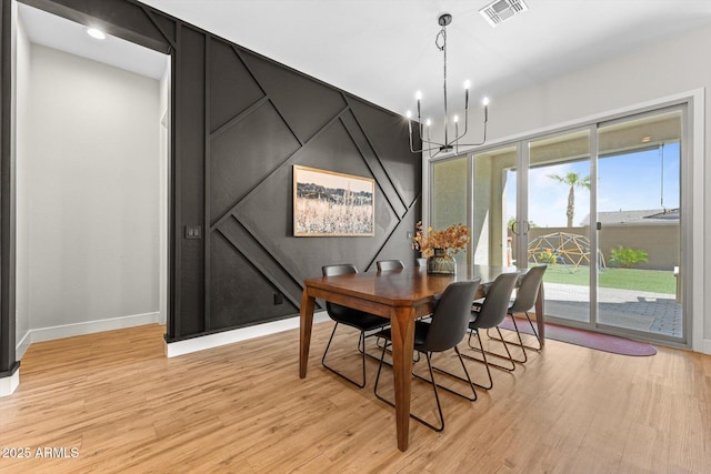 141 S 156th Dr, Goodyear, AZ 85338 - dining room featuring light wood finished floors, visible vents, baseboards, and an inviting chandelier