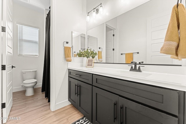 141 S 156th Dr, Goodyear, AZ 85338 - bathroom featuring toilet, wood finished floors, vanity, and baseboards