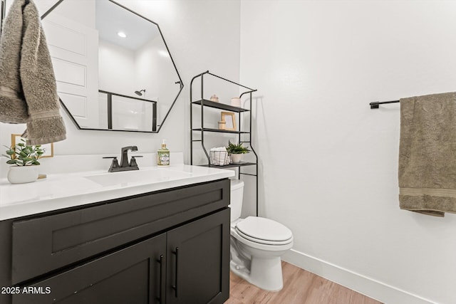 141 S 156th Dr, Goodyear, AZ 85338 - bathroom with vanity, toilet, a shower, wood finished floors, and baseboards