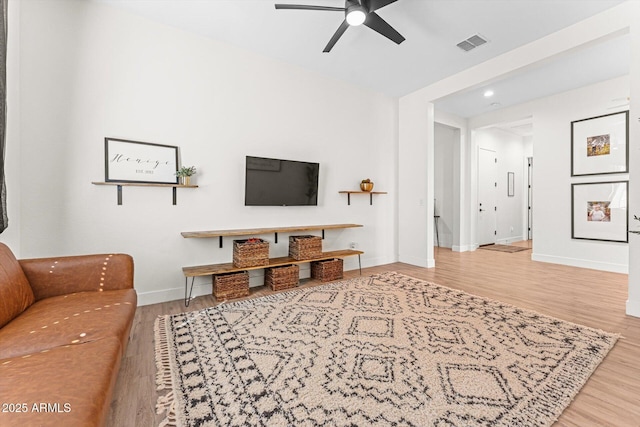 141 S 156th Dr, Goodyear, AZ 85338 - living room with visible vents, baseboards, a ceiling fan, and wood finished floors