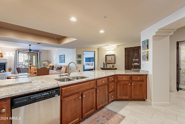 kitchen with dishwasher, ceiling fan, light stone countertops, and sink