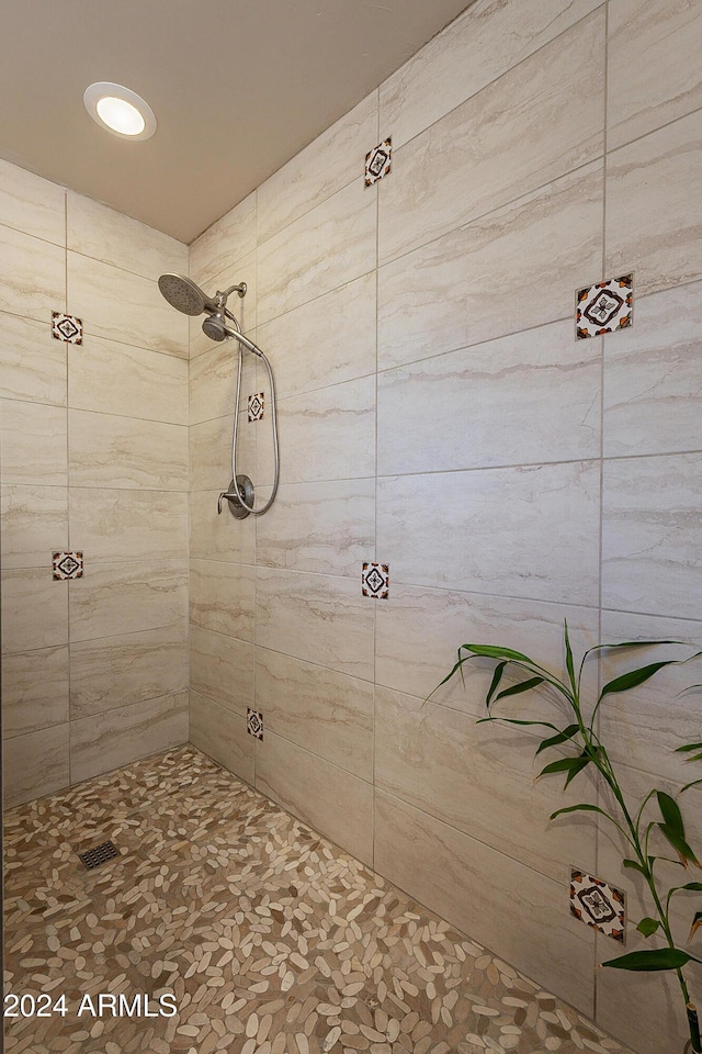 bathroom with a tile shower