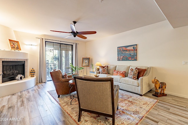 living room with ceiling fan and light wood-type flooring