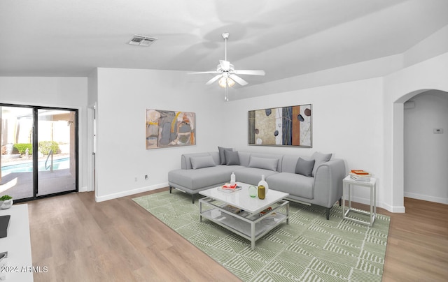 living room featuring hardwood / wood-style flooring, ceiling fan, and lofted ceiling