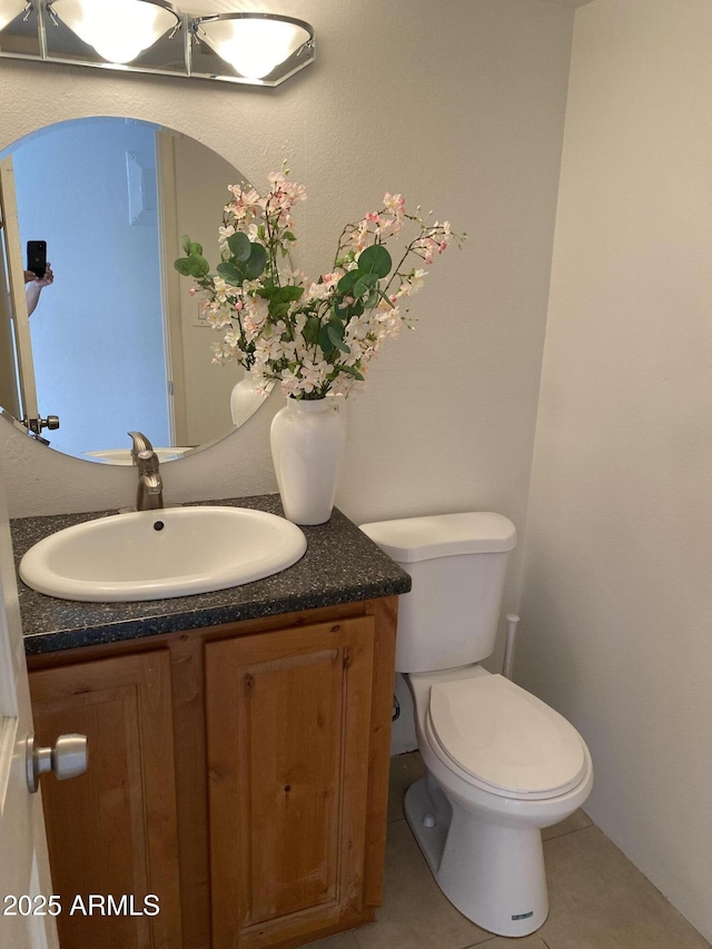 bathroom featuring vanity, toilet, and tile patterned floors