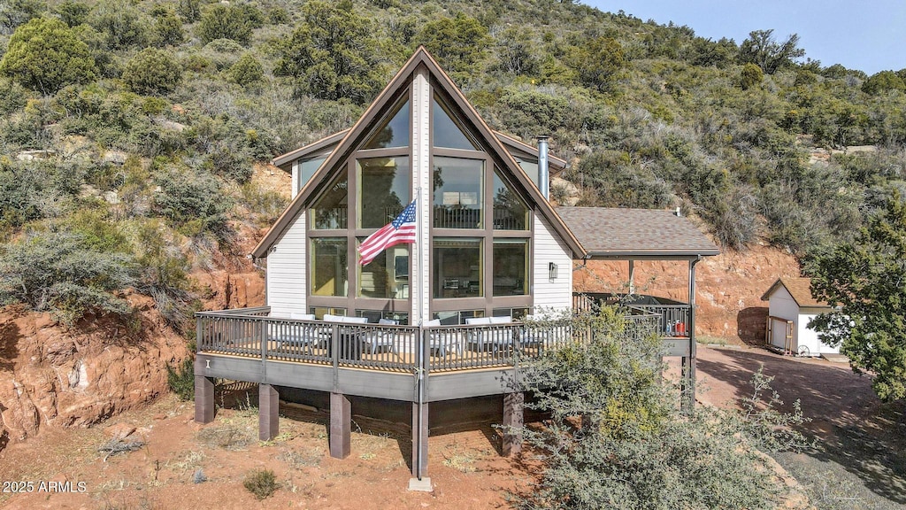 rear view of house featuring a deck