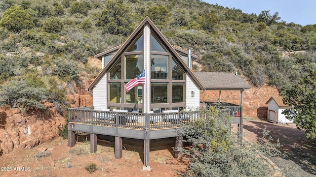 rear view of house featuring a deck