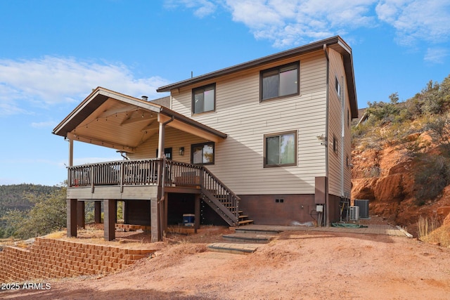 rear view of house featuring cooling unit and a deck