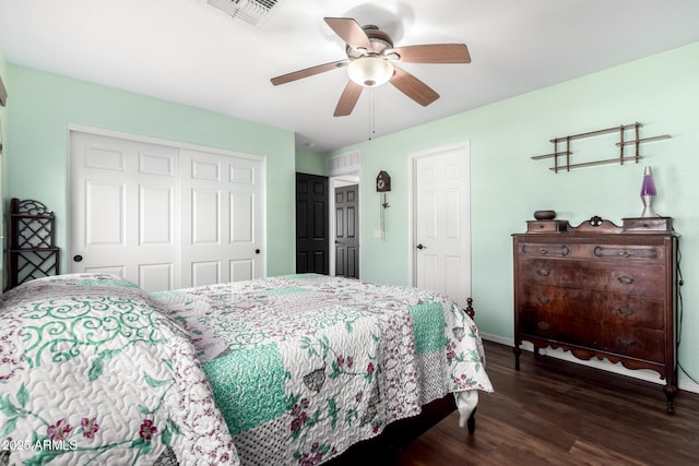 bedroom with a closet, ceiling fan, and dark wood-type flooring