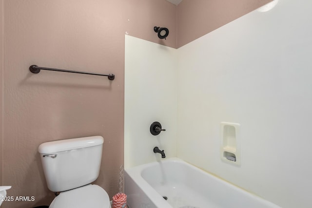 bathroom with shower / bath combination and toilet