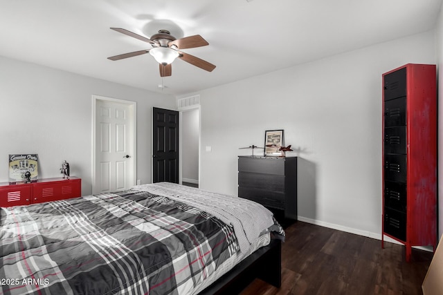 bedroom with ceiling fan and dark hardwood / wood-style floors