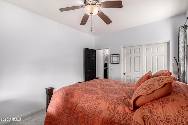 carpeted bedroom with ceiling fan and a closet