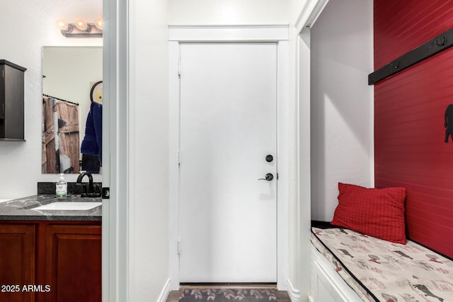 interior space featuring a shower with shower curtain and vanity