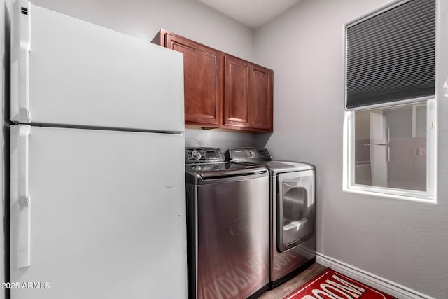 washroom with cabinets and independent washer and dryer