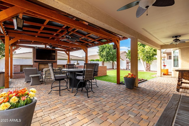 view of patio / terrace featuring ceiling fan and exterior kitchen