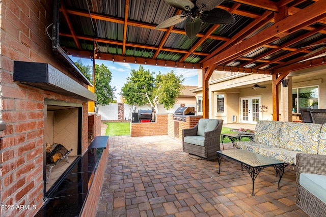 view of patio / terrace with outdoor lounge area, french doors, an outdoor kitchen, ceiling fan, and area for grilling