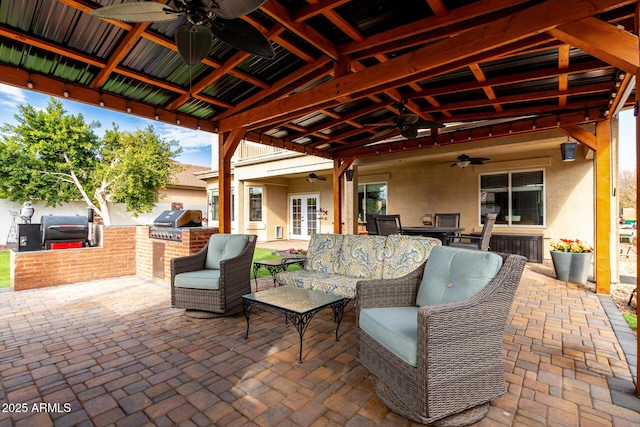 view of patio with an outdoor living space, a grill, exterior kitchen, and french doors